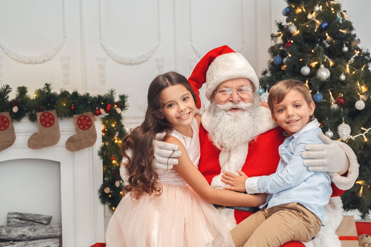 Santa Claus with children indoors holiday concept smiling