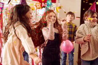 Children dancing and celebrating at birthday party