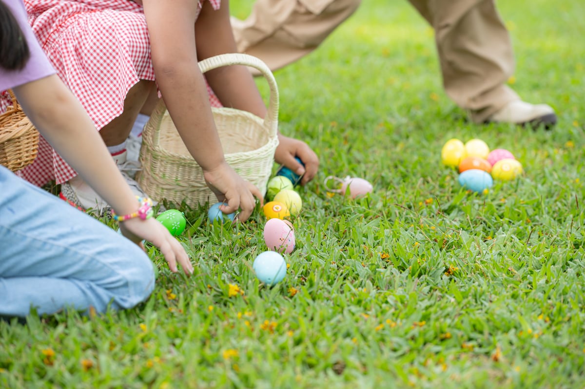 Children enjoying outdoor activities in the park including a run to collect beautiful Easter eggs.