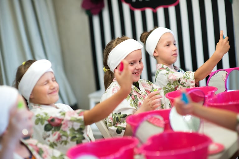 Young girls relaxing at spa party with face masks and beauty treatments