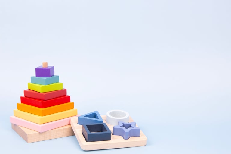 Educational and sensory wooden Montessori toys. Wooden stacking pyramid and geometric shapes board.