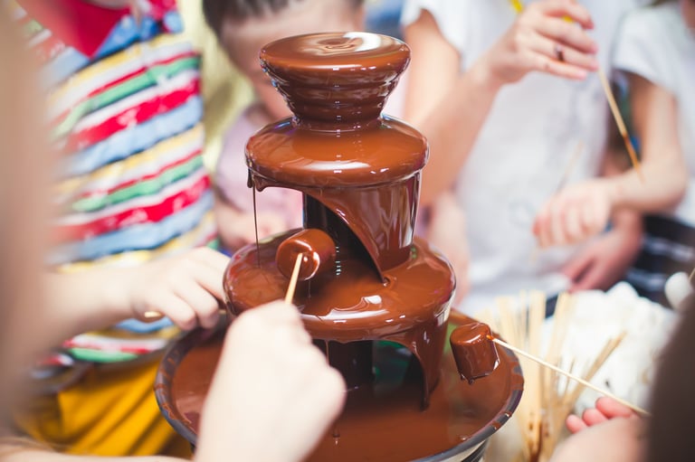 Chocolate fountain at kids birthday party with marshmallows and fruits